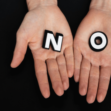 Hands holding letters spelling "NO," symbolizing the importance of setting boundaries in association management.